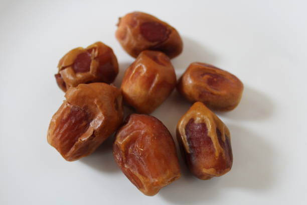 Close up of date fruit on white background.