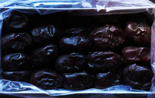 Photograph of a box of fresh organic mazafati dates for food background