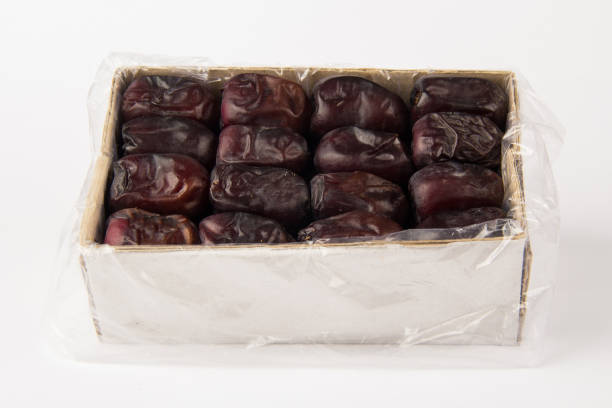 Box with dates fruit on white background
