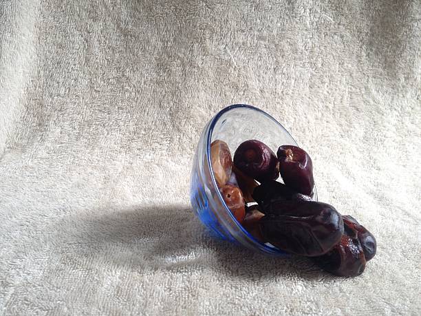Fresh dates in a bowl with shadowy background