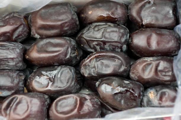 Delicious dried dates background in plastic bag