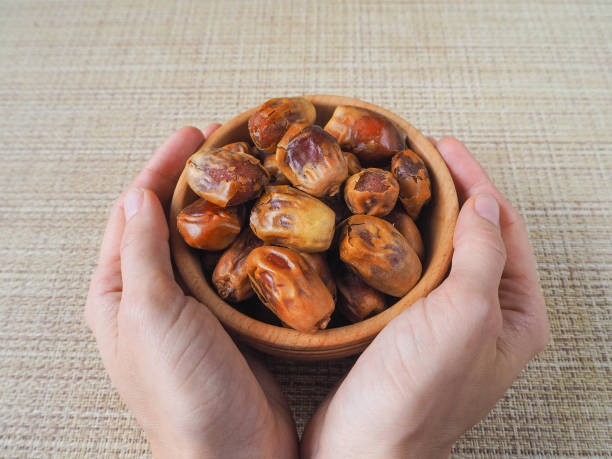 Delicious fresh organic dates over white background